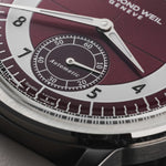 Close-up of Raymond Weil Millesime tuxedo sector dial with burgundy centre, light grey hour ring, and small seconds at 6 o’clock